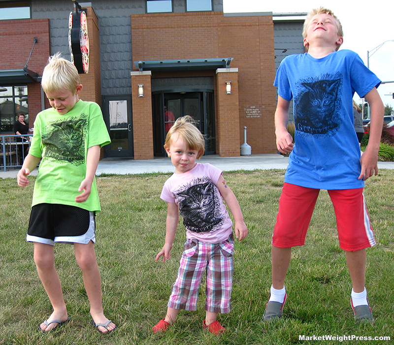 3 kids dance with their GrrrKitty t-shirts on