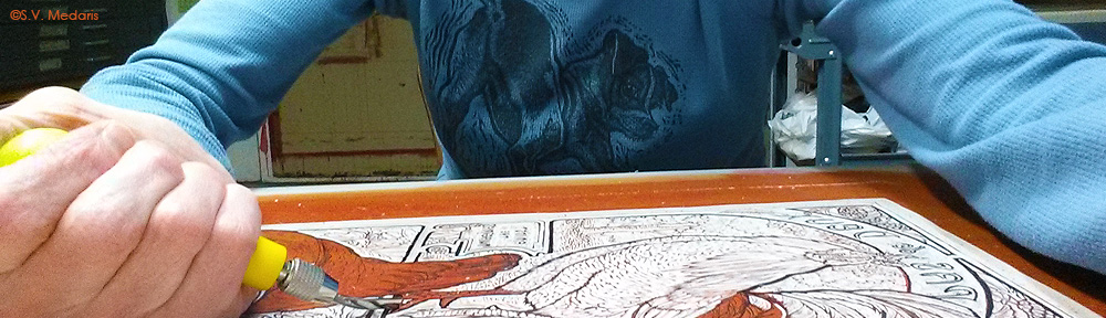 artist carves chickens in lino block (Pas de Deux) with gouge tool