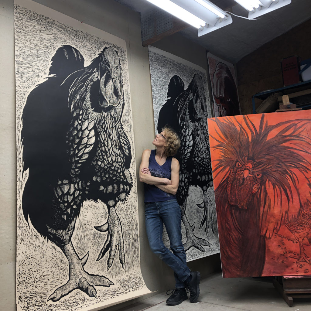 Artist S.V. Medaris rests after printing the 8ft woodcut, 'Cock 'O the Walk'